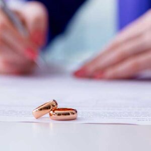 person-signing-prenuptial-agreement